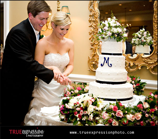 bride and groom cutting the wedding cake at Brookstone Country Club